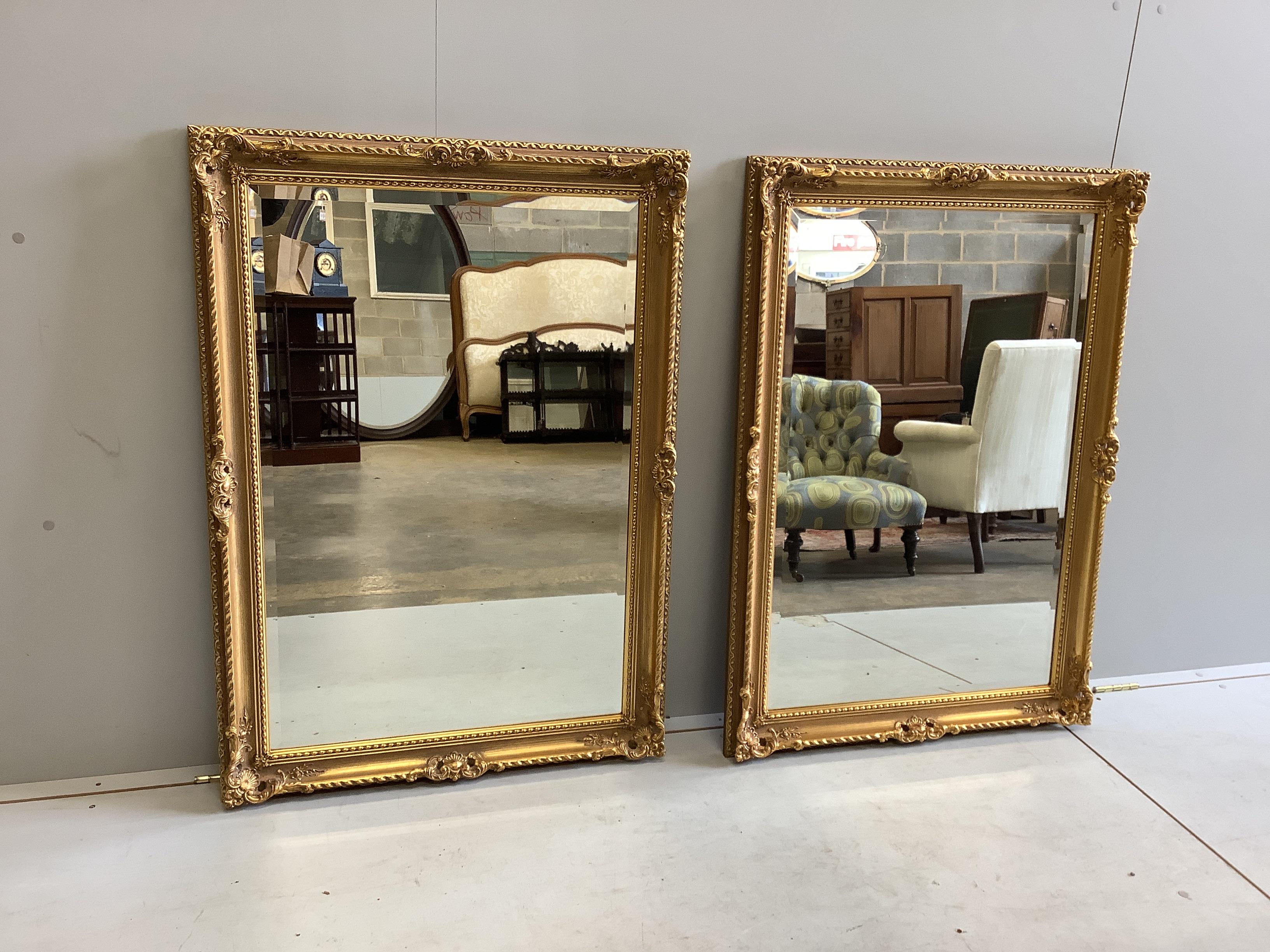 A pair of Victorian style gilt composition wall mirrors, width 75cm, height 107cm